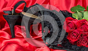 Sexy red  satin background and black knickers shoe red roses