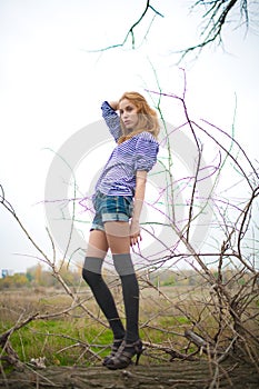 Sexy redhead girl in stockings in nature