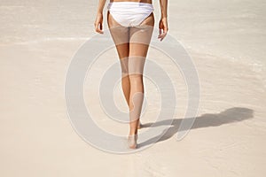 sandy woman buttocks on tropical beach photo