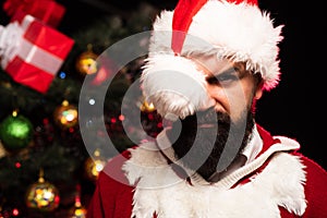 Sexy Santa. A bearded man in a hat of Santa Claus is looking at the camera. Discounts at a clothing store before the new