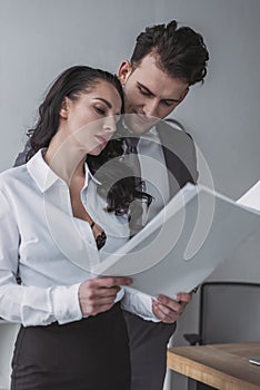 Sexy secretary showing white papers to