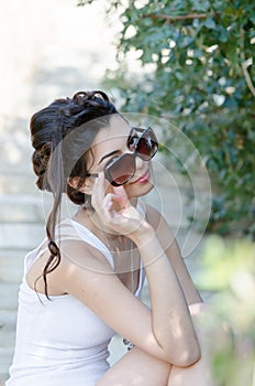 slim lady wear tight short white dress and sunglasses