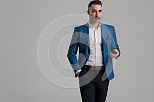 Sexy smartcasual man holding hand in a fashion pose