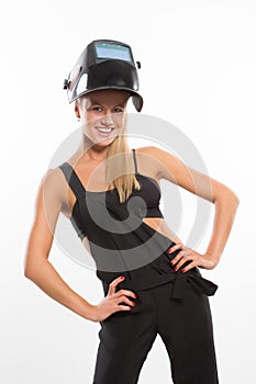 smiling woman in welder helmet