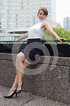 Sexy, sophisticated woman poses in urban city area