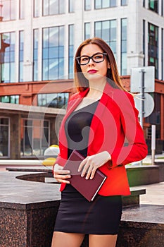 Sexy successful confident business woman standing near office