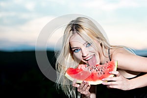 Sexy summer tropical fruit. Sensual young woman lick watermelon with sexy tongue. Funny beautiful young blonde woman