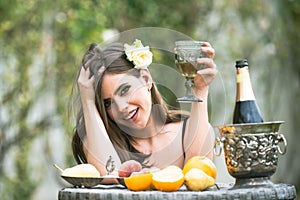 Sexy summer tropical fruit. Young beautiful model on vacation holiday outdoor. Beautiful Young Woman Drinking Wine In