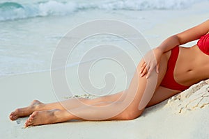 Sexy Suntan Bikin Woman Legs Relaxing Lying Down near Beach.  Beauty Skincare.