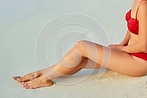 Sexy Suntan Bikin Woman Legs Relaxing Lying Down near Beach In Resort Spa Hotel On Travel Holidays Vacation. Beauty Skincare. P