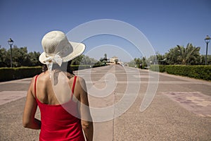 Sexy tourist woman entered the gardens of the menara of Marrakech and enjoy the construction of the ancient Almoravids