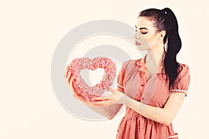 Valentine model Girl portrait. Gorgeous Valentines young brunette woman with heart shaped gift. Perfect make up