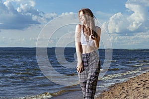 Sexy Winsome Young Happy Smiling Caucasian Brunette Girl Posing in Beach Clothing While Resting and Having Fun At Seashore During