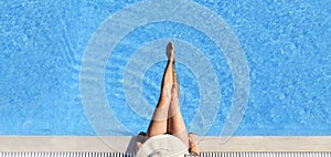 Sexy woman in bikini and sunhat relaxing in swimming pool photo