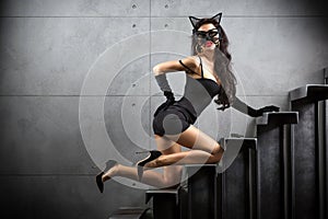 woman in catwoman suit lying on stairs photo