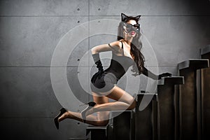woman in catwoman suit lying on stairs photo