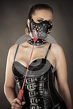 woman in corset and mask with spikes