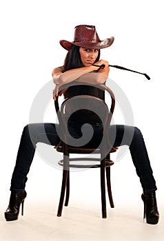 woman in cowboy hat sits on chair photo