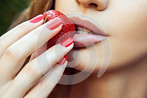 Woman Eating Strawberry. Sensual Red Lips. Red Manicure and Natural Lipstick.