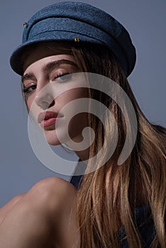 Sexy woman face. Sensual young woman posing with fashion cap hat. Beautiful sexy model. Beauty female face. Sensual girl