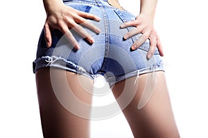 woman in fashion blue jeans shorts. Perfect hot booty and erotic curves hips. Good body shapes whithout cellulite photo