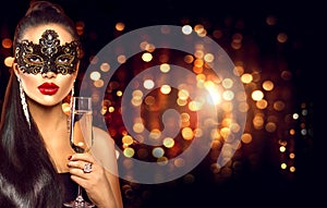 woman with glass of champagne wearing venetian masquerade mask photo