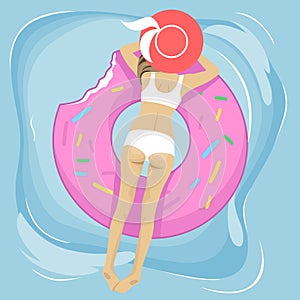 woman and inflatable swim ring in shape of a donut in the pool