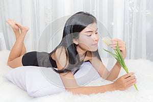 woman lingerie dress holding flower and lie down on the bed