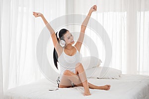 Sexy woman listening to musics in bedroom photo