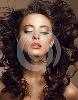 Woman with Long Windy Brown Hair and Saturated Makeup photo