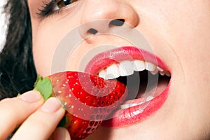 woman mouth biting strawberry