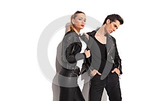 woman pulling her lover by his leather jacket