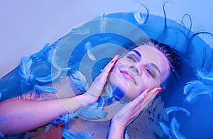 Sexy woman relaxing in bathroom. Facial spa treatment for beauty and health skin care. Bath time.