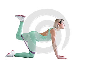 Sexy woman in sportswear using a resistance band in her exercise