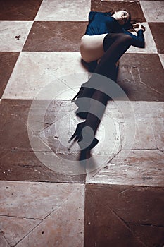 woman in stockings lyingon chess board type floor