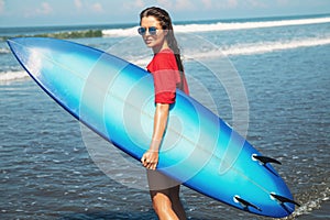 Sexy woman surfer with shortboard on the beach photo