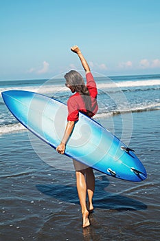 Sexy woman surfer with shortboard on the beach photo