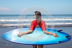 Sexy woman surfer with shortboard on the beach photo