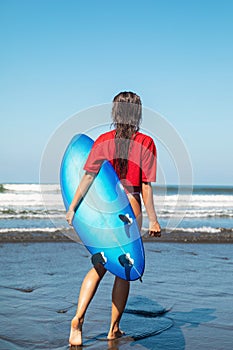 Sexy woman surfer with shortboard on the beach photo