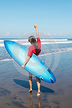 Sexy woman surfer with shortboard on the beach photo