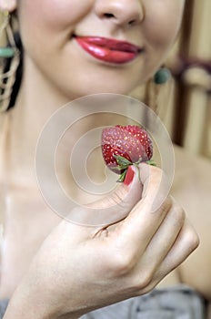 woman tasting a strawberry