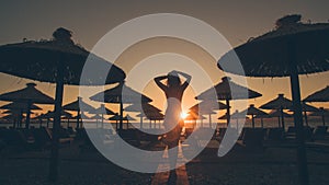 woman walk on beach at sunset