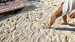 Sexy woman walking on the white sand of a Caribbean beach