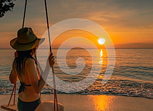 Sexy woman wear bikini and straw hat swing the swings at tropical beach on summer vacation at sunset. Girl in swimwear