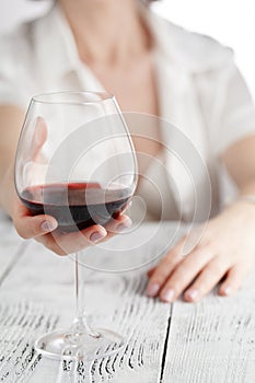 woman in white holding wine glass