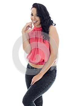 Young Cheeky Hispanic Woman Posing In A Pink Top and Black Jeans photo