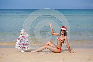 The young girl on a beach in Santa Claus's dress