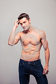 young man posing over gray background