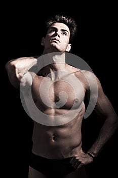 young man shirtless. Gym muscular body. Neck pain. photo