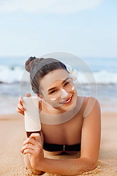 Sexy Young Woman in Bikini Holding Bottles of Sunscreen in Her Hands. Skincare. A Beautiful Female Applying Sun Cream.